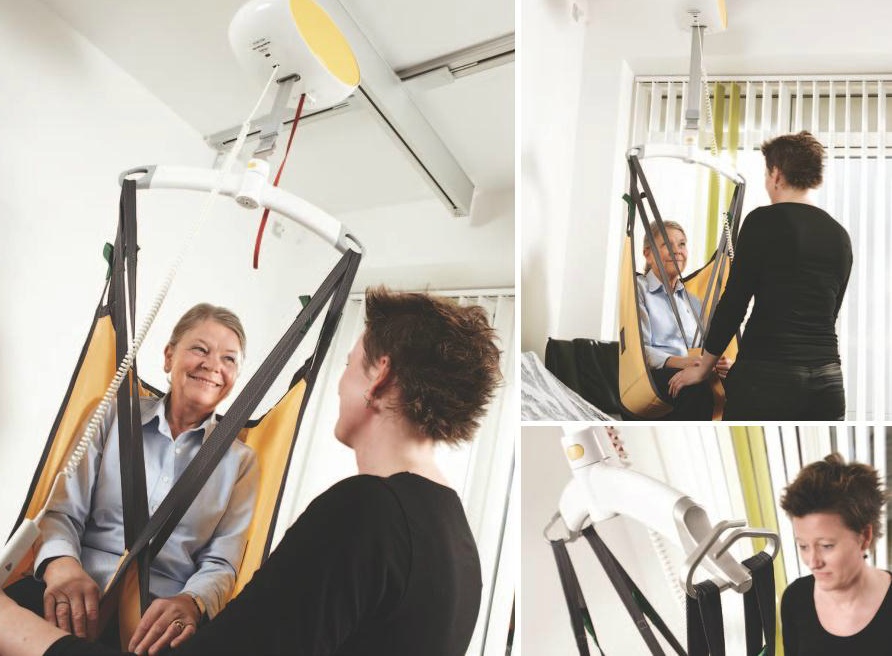 En kvinde sidder i sejlet, som bæres af loftlift. Hun bliver forflyttet af kvinde. Nærbillede af loftliftens arme, der bærer sejlet. Loftlift er monteret i skinne i loft.